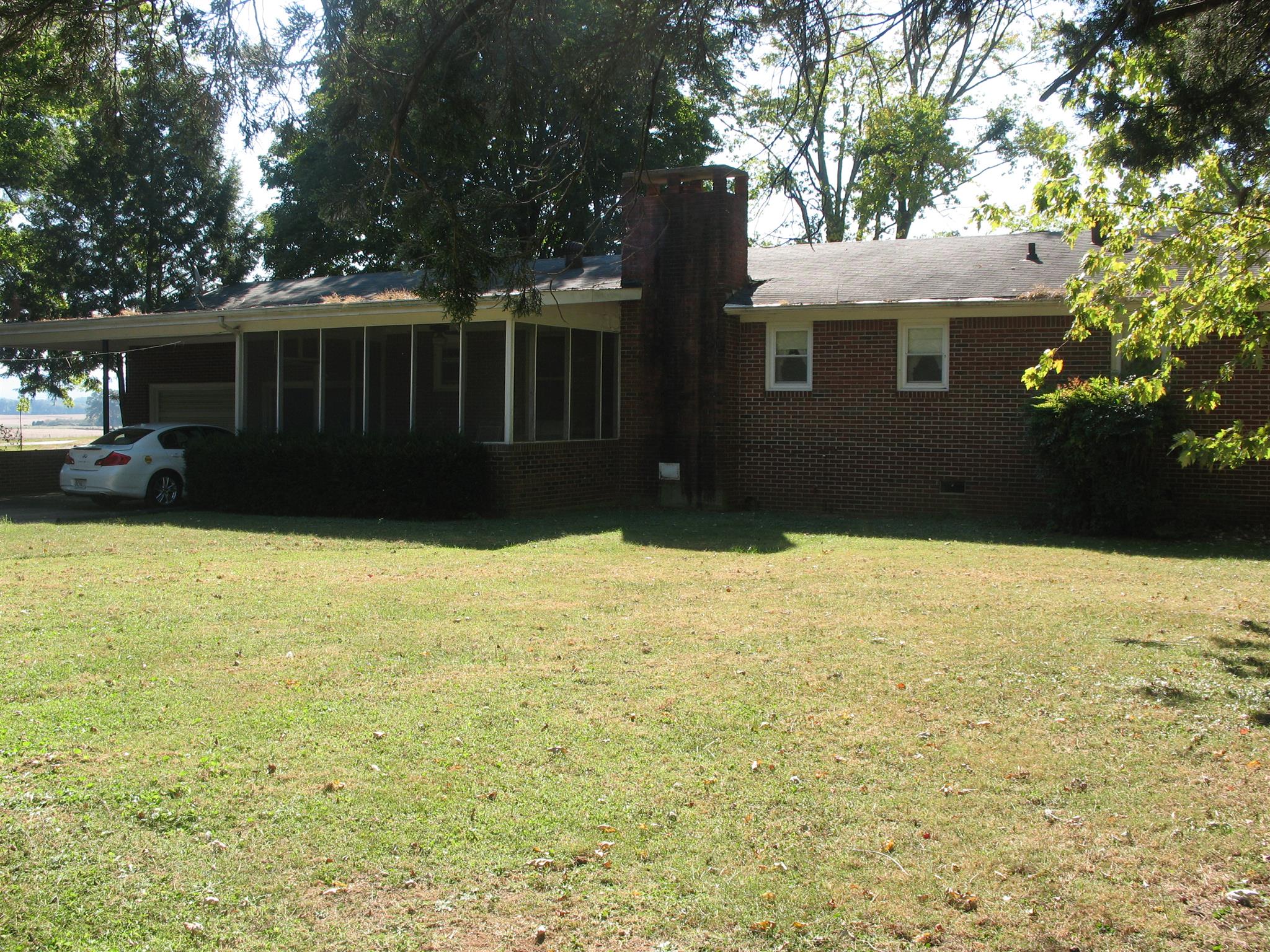 back view with screened porch and car port