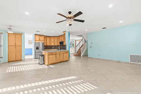a view of a livingroom with a ceiling fan and window