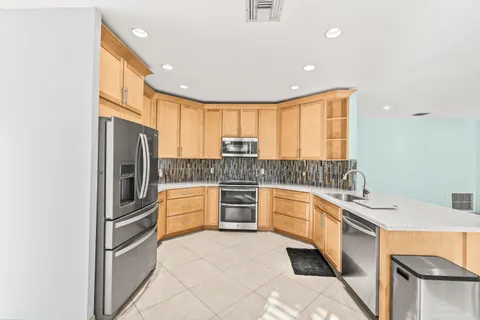 a kitchen with a sink stove and cabinets