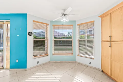 a view of kitchen with stainless steel appliances granite countertop a stove a sink and a microwave