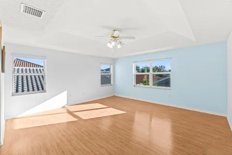 a view of an empty room with wooden floor