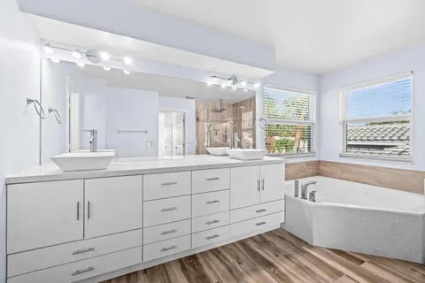 a bathroom with a shower a bathtub and a shower