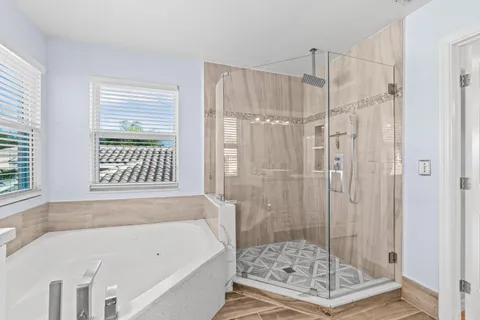 a spacious bathroom with a shower sink and mirror