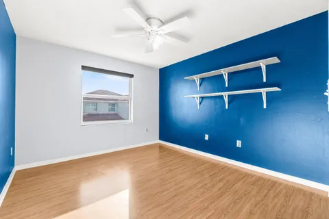 a view of an empty room with wooden floor
