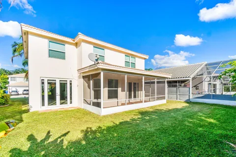 a view of a house with a big yard and potted plants