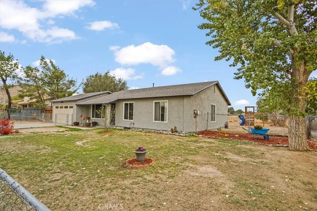 a view of a house with a backyard