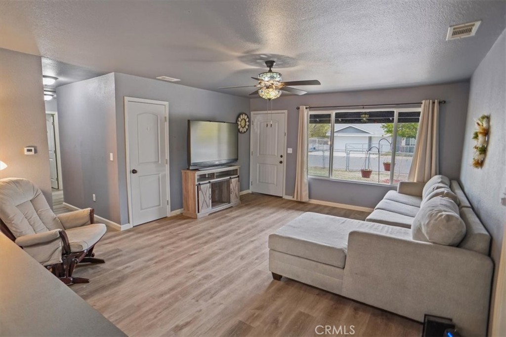 40287 Fieldspring Street Palmdale, CA 93591 - Photo 2 of 14 a living room with furniture and a flat screen tv