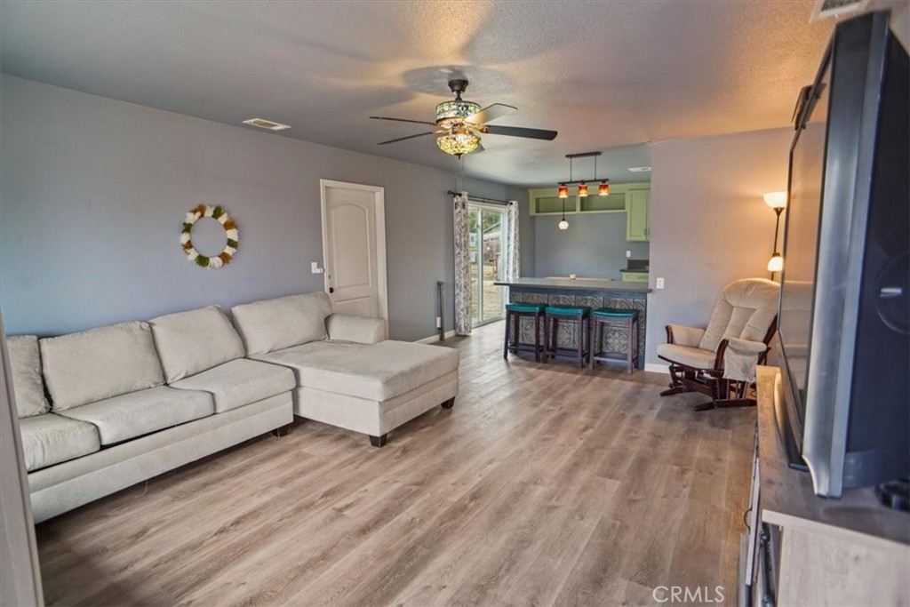 40287 Fieldspring Street Palmdale, CA 93591 - Photo 3 of 14 a living room with furniture and a chandelier