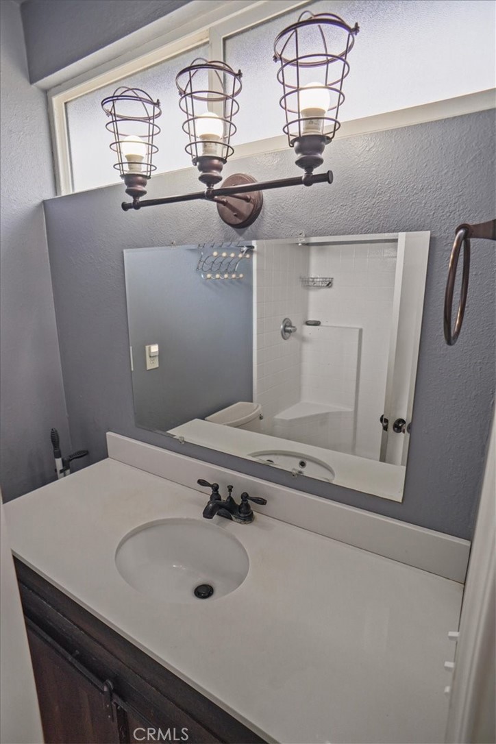 40287 Fieldspring Street Palmdale, CA 93591 - Photo 6 of 14 a bathroom with a sink and a mirror
