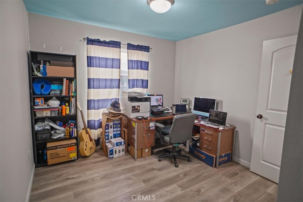 40287 Fieldspring Street Palmdale, CA 93591 - Photo 8 of 14 a view of a workspace with furniture and wooden floor