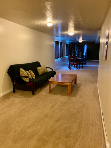3918 Mapleleaf Way West Jordan, UT 84088 - Photo 3 of 12 Living room with a textured ceiling and light colored carpet