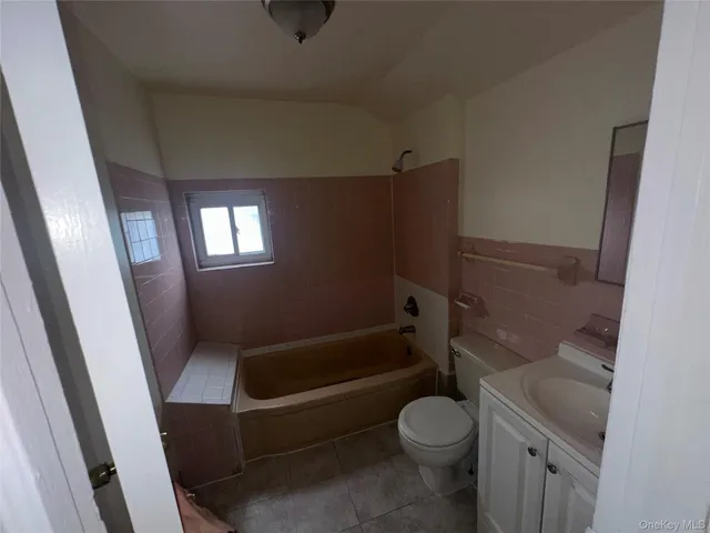 a bathroom with a toilet and a tub