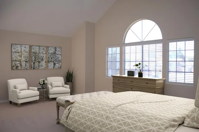 a bedroom with a bed and glass window