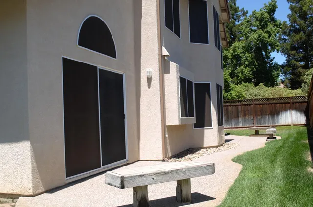 a view of house with backyard porch and furniture