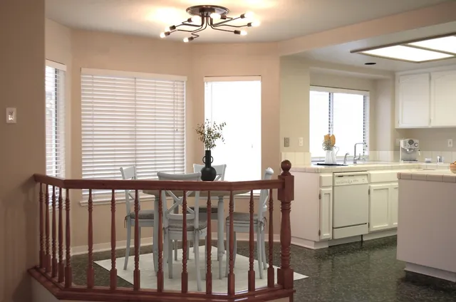 a kitchen that has a lot of cabinets in it with wooden floor