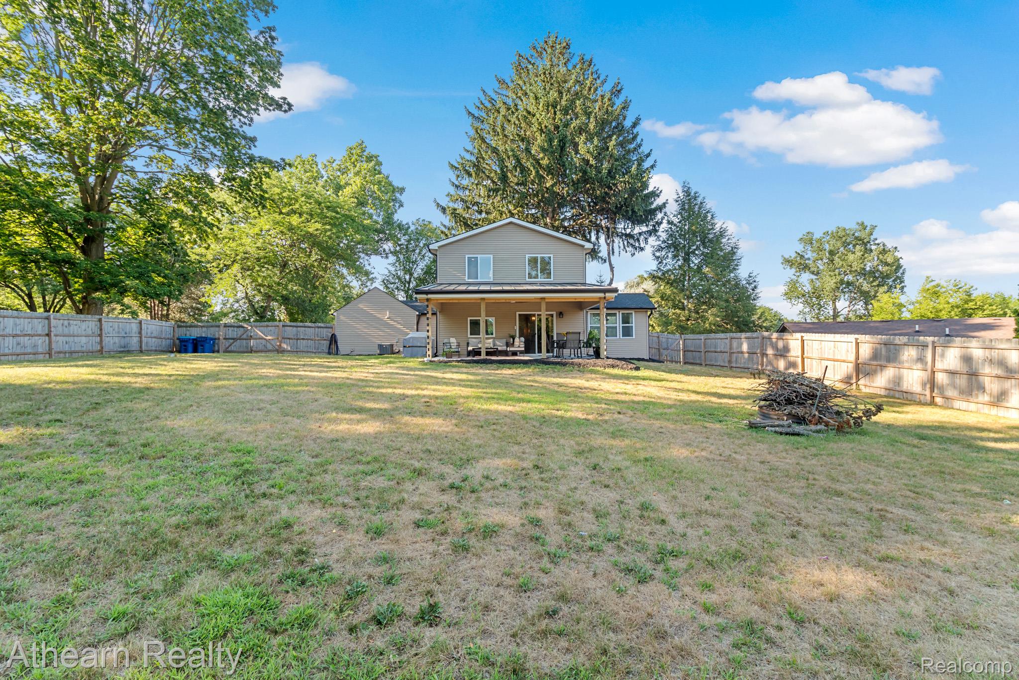 5079 West Thompson Road Linden, MI 48451 - Photo 4 of 27 Expansive grounds featuring a generous grassy lawn dotted with mature trees and established landscaping