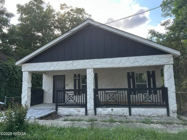 a front view of a house with wooden fence