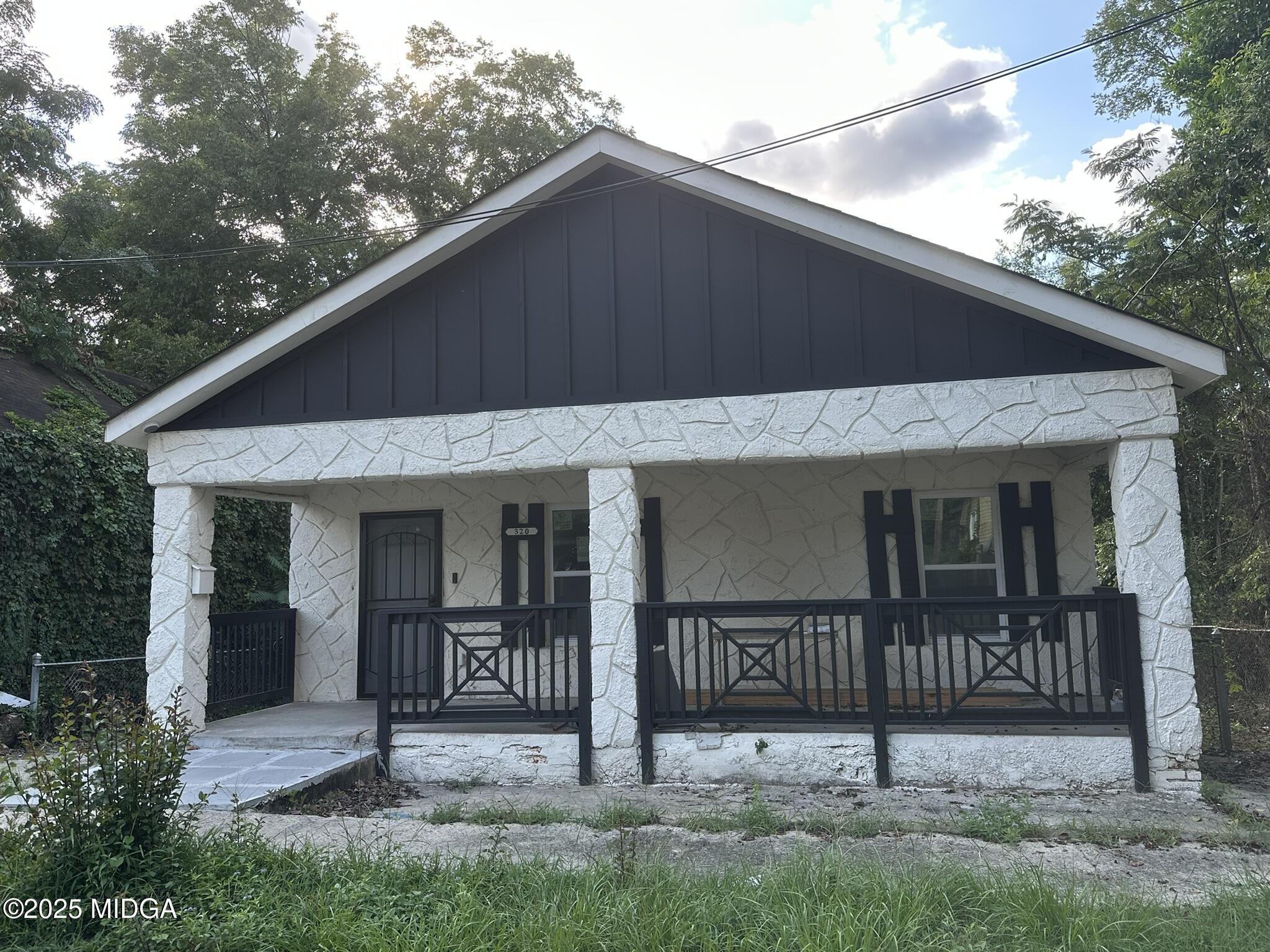 a front view of a house with wooden fence
