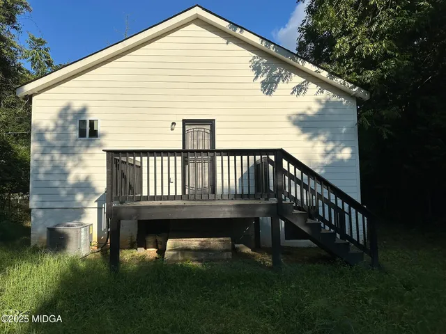 a view of a house with backyard porch and sitting area