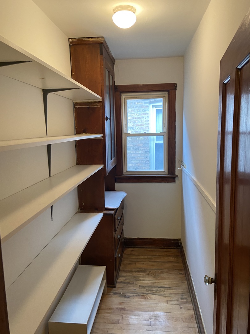 2143 West Superior Street, Unit 2F Chicago, IL 60612 - Photo 5 of 10 a view of walk in closet with empty racks