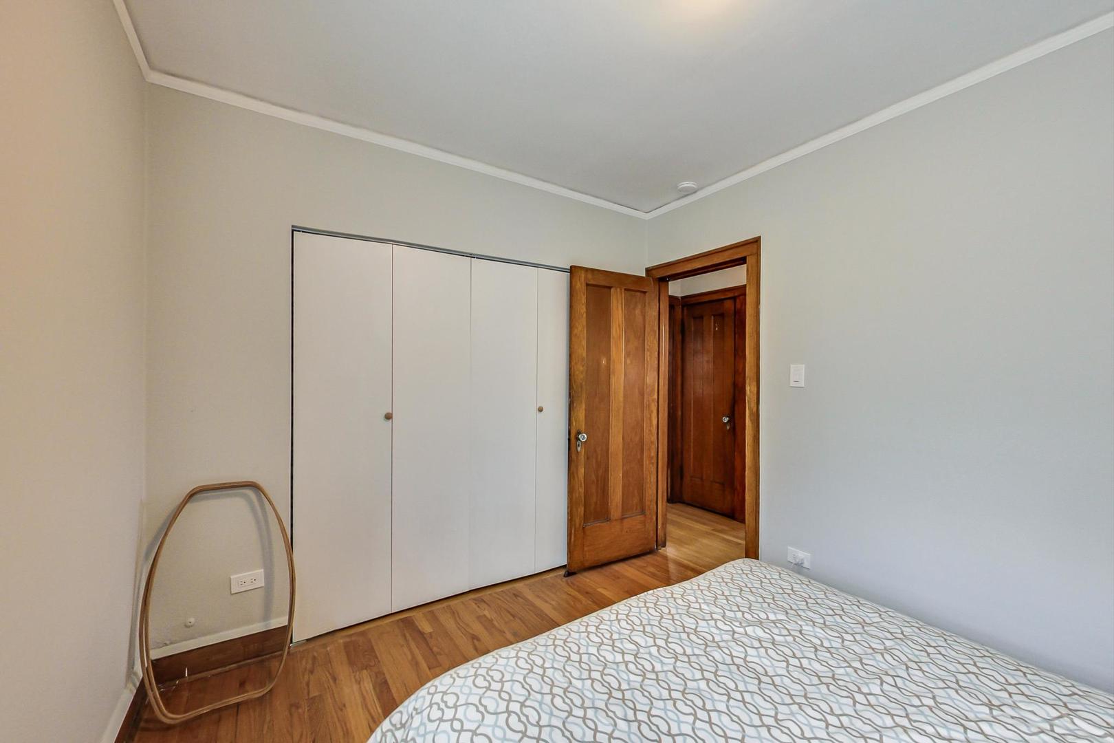 2143 West Superior Street, Unit 2F Chicago, IL 60612 - Photo 8 of 10 a bedroom with a bed and a dresser