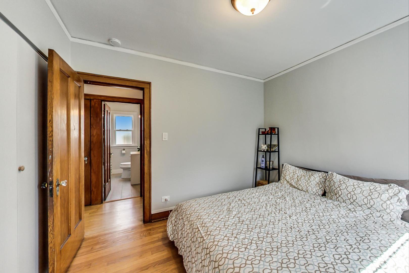 2143 West Superior Street, Unit 2F Chicago, IL 60612 - Photo 10 of 10 a bedroom with a bed and wooden floor