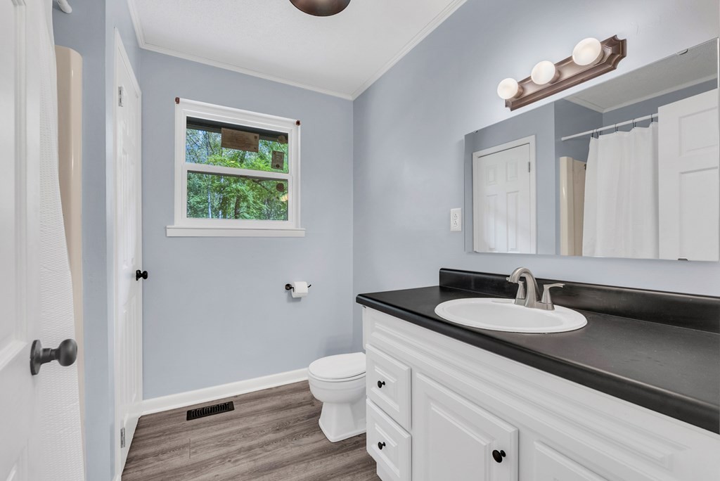 121 Twin Oaks Road Pikeville, TN 37367 - Photo 11 of 22 a bathroom with a granite countertop sink and a mirror