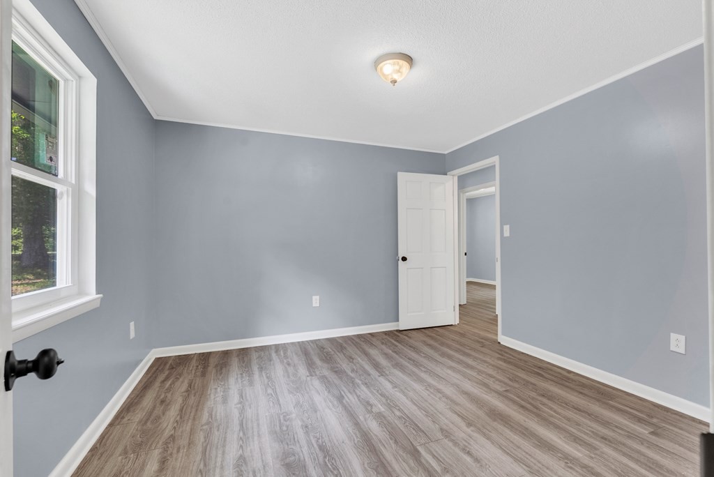 121 Twin Oaks Road Pikeville, TN 37367 - Photo 13 of 22 a view of an empty room with wooden floor and a window