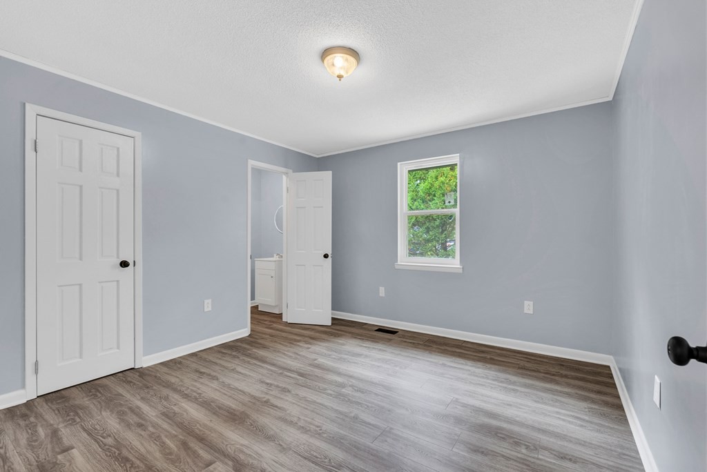 121 Twin Oaks Road Pikeville, TN 37367 - Photo 14 of 22 an empty room with wooden floor and window