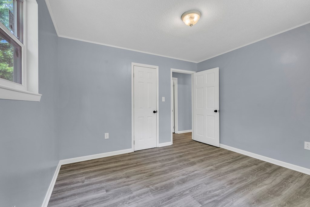 121 Twin Oaks Road Pikeville, TN 37367 - Photo 15 of 22 a view of an empty room with wooden floor and a window