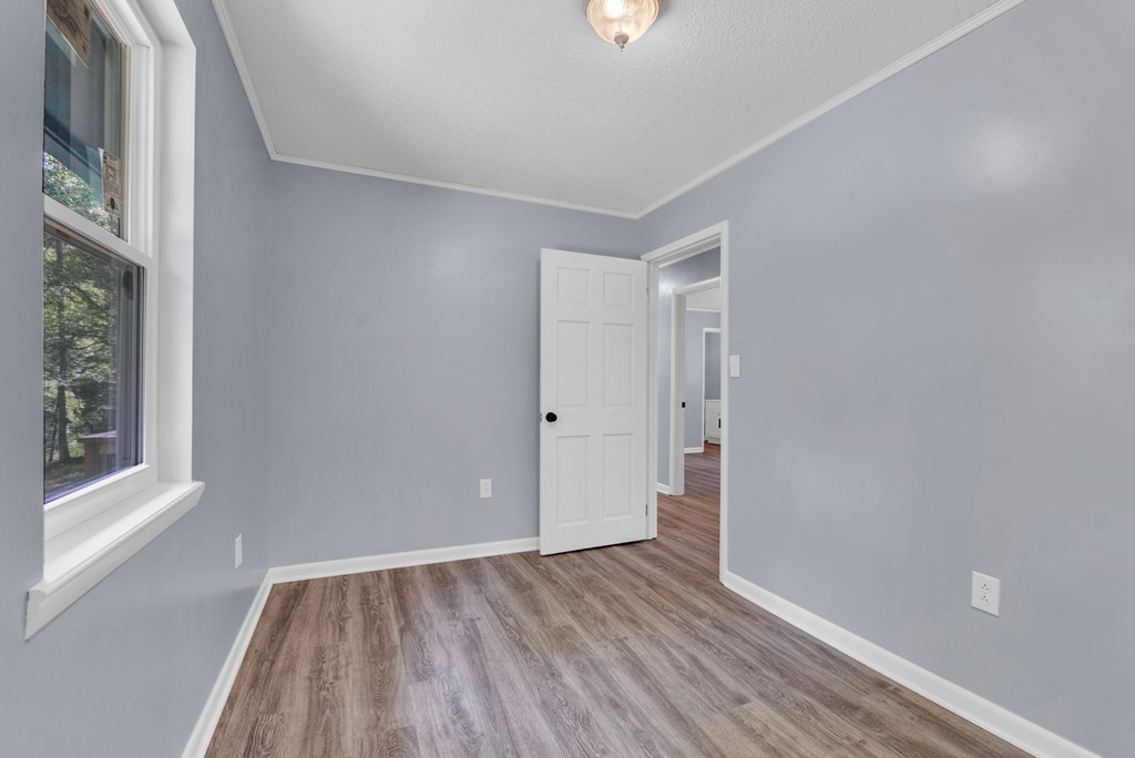 121 Twin Oaks Road Pikeville, TN 37367 - Photo 17 of 22 a view of an empty room with wooden floor and a window