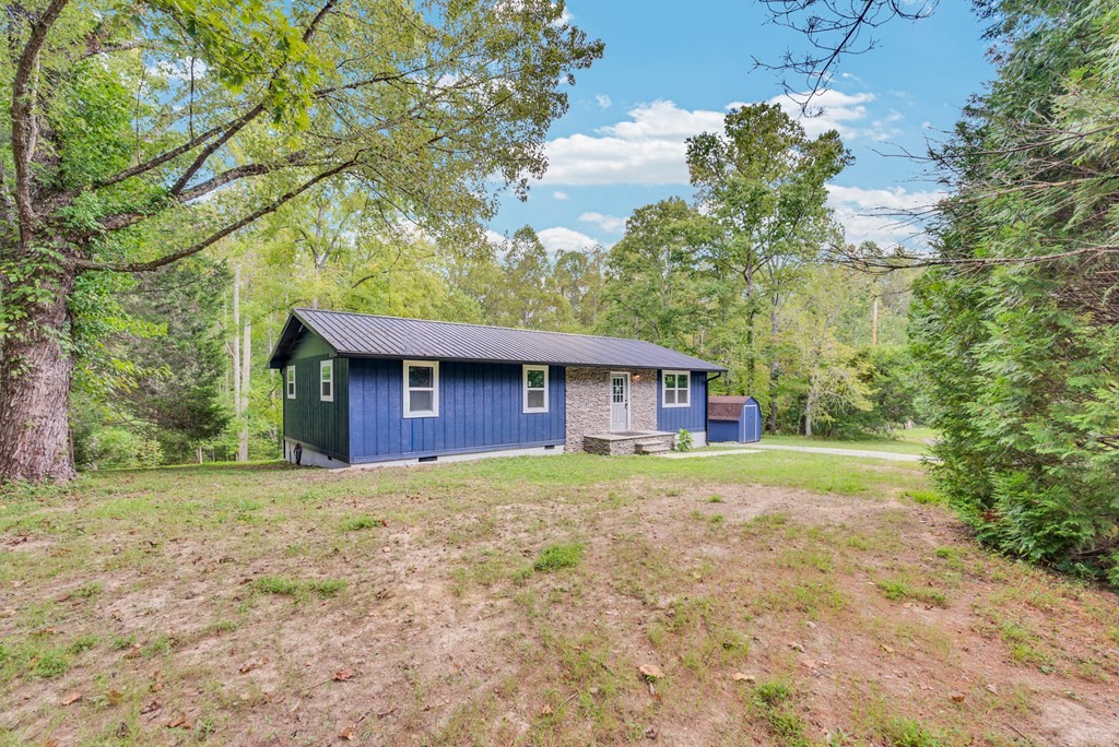 121 Twin Oaks Road Pikeville, TN 37367 - Photo 2 of 22 a house is sitting in middle of the forest
