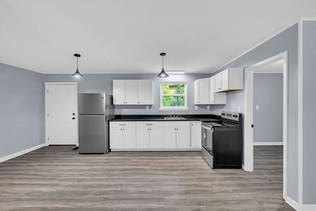 121 Twin Oaks Road Pikeville, TN 37367 - Photo 9 of 22 a kitchen with stainless steel appliances granite countertop a refrigerator and a stove top oven