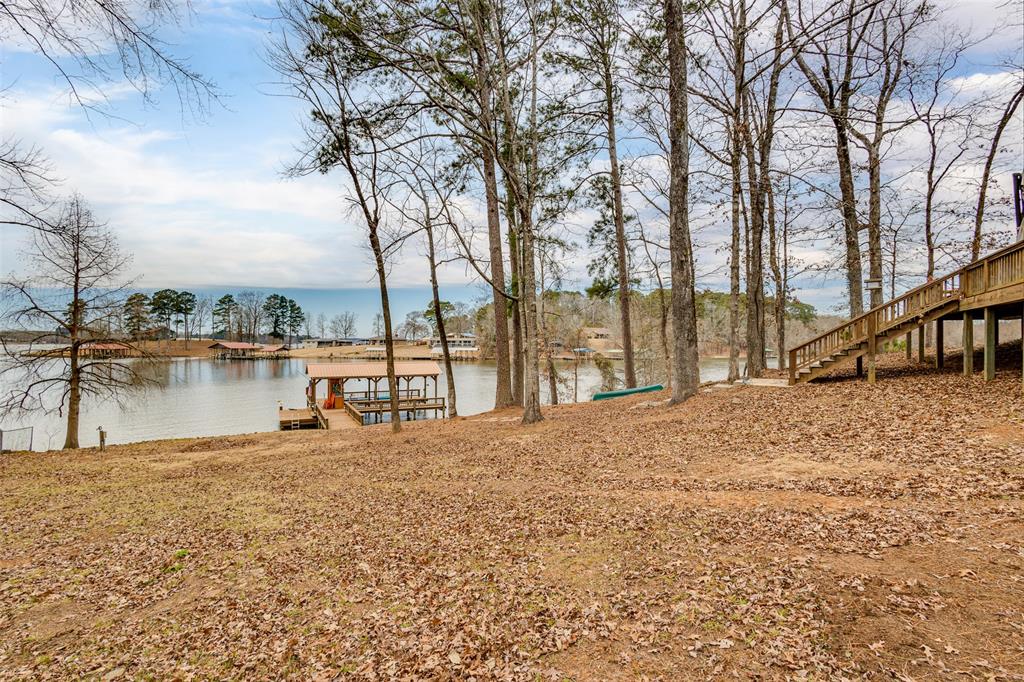 638 Featherston Road Homer, LA 71040 - Photo 6 of 10 View of yard featuring a boat dock, a water view, and stairs