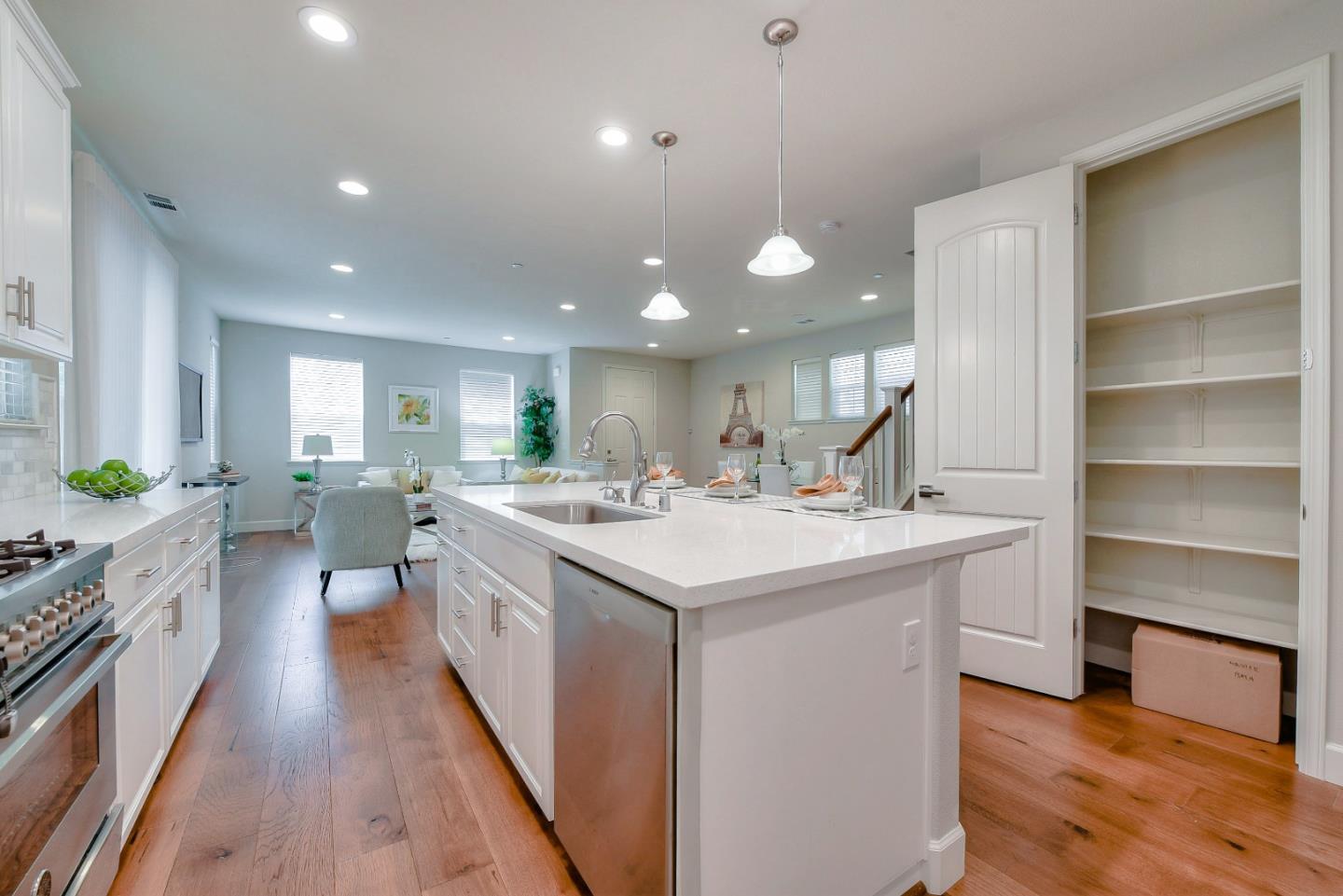 171 Cobblestone Loop Milpitas, CA 95035 - Photo 12 of 41 a large kitchen with kitchen island a sink a stove and a wooden floors