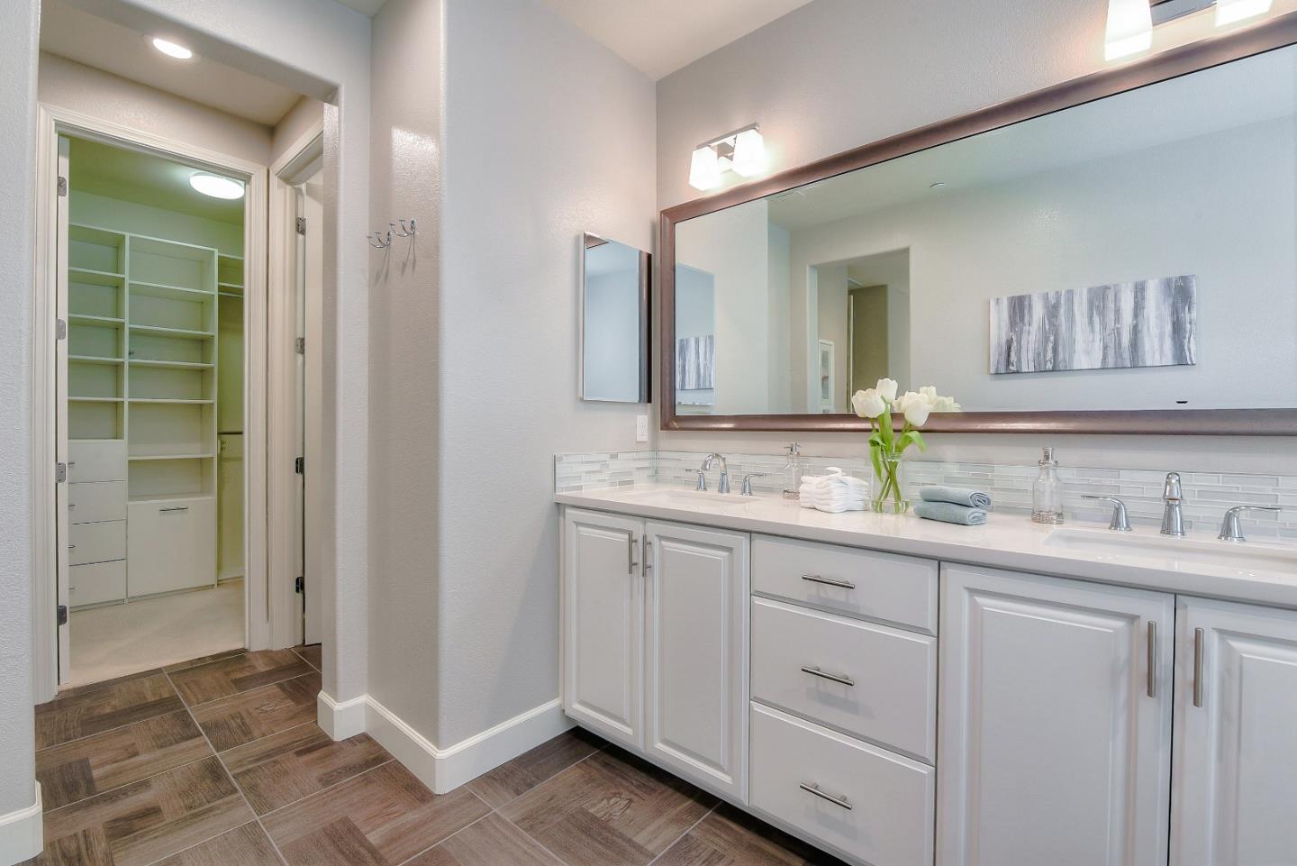 171 Cobblestone Loop Milpitas, CA 95035 - Photo 31 of 41 a bathroom with double sink and a mirror