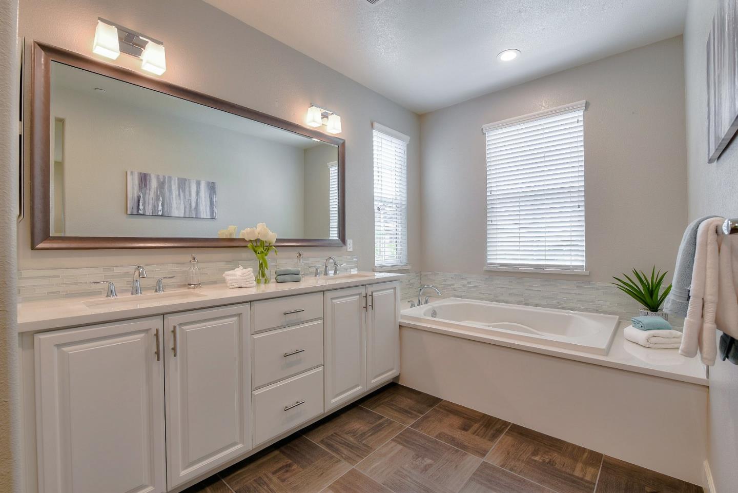 171 Cobblestone Loop Milpitas, CA 95035 - Photo 32 of 41 a bathroom with a bathtub a sink and a window