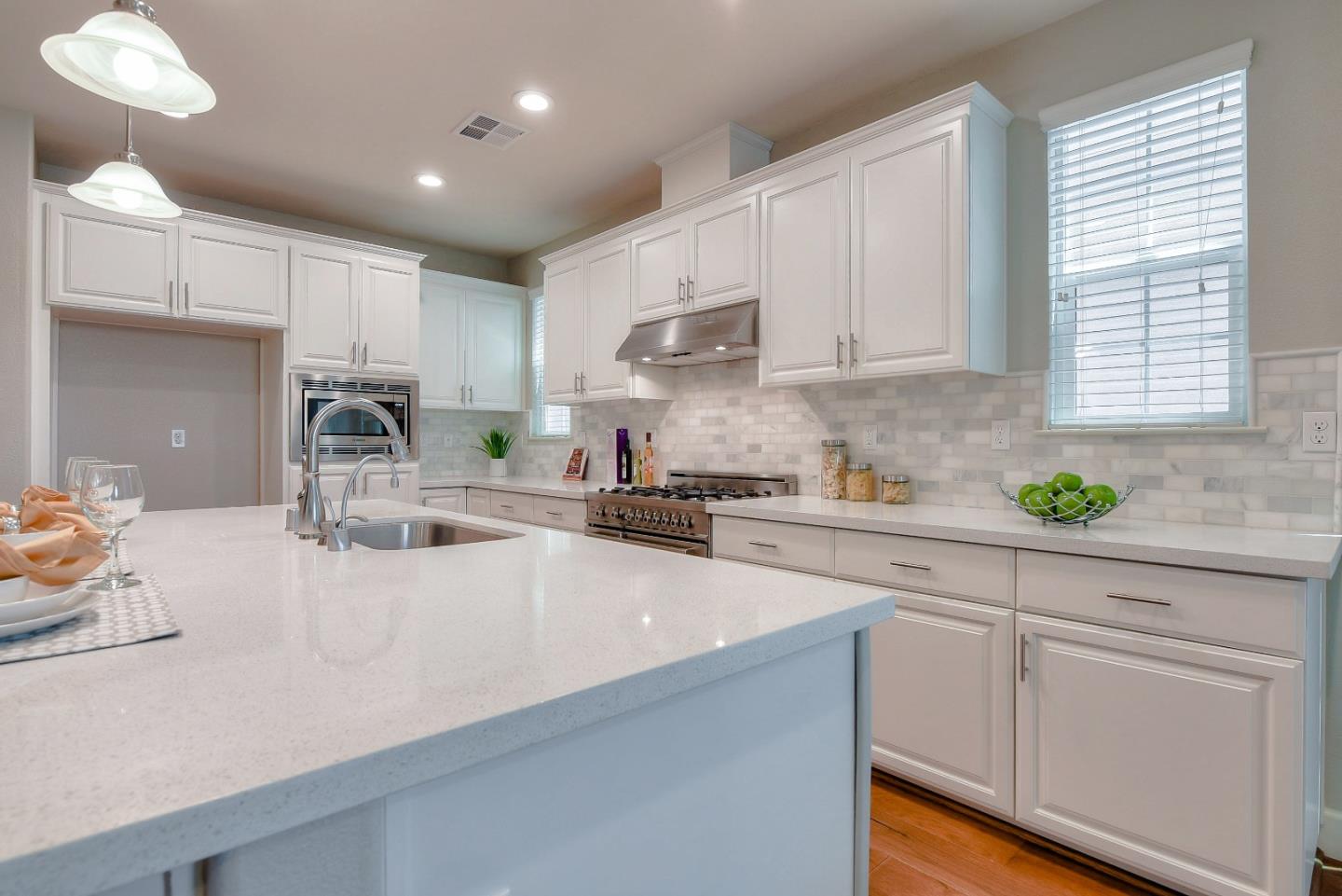 171 Cobblestone Loop Milpitas, CA 95035 - Photo 5 of 41 a kitchen with kitchen island white cabinets and white appliances