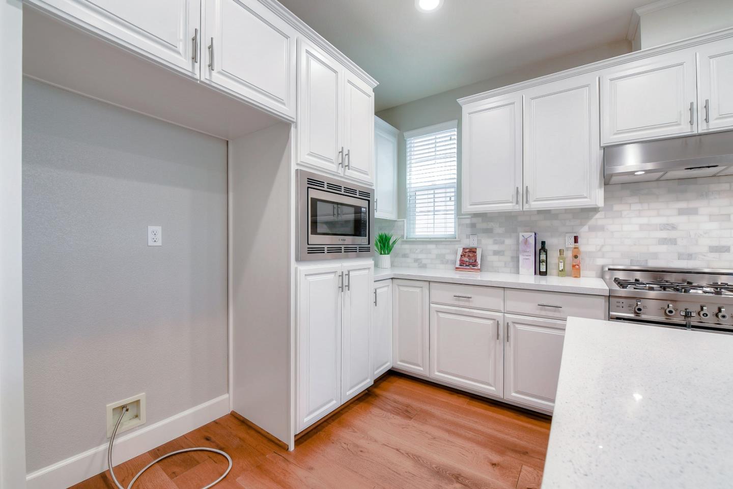171 Cobblestone Loop Milpitas, CA 95035 - Photo 9 of 41 a kitchen with white cabinets stainless steel appliances and sink