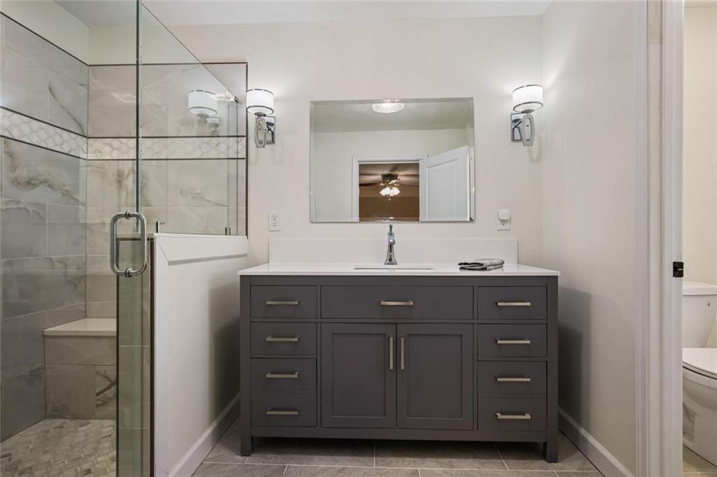 4505 Cochran Mill Road Fairburn, GA 30213 - Photo 22 of 36 a bathroom with a sink vanity and mirror
