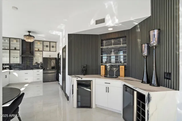 a kitchen that has a sink a stove and chairs