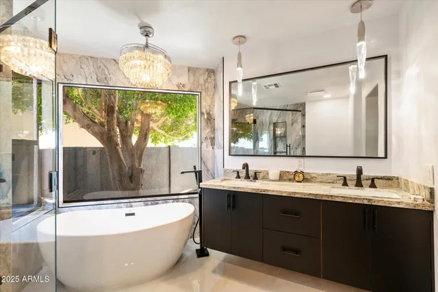 a bathroom with a tub sink and mirror