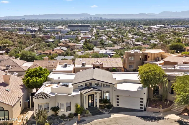 an aerial view of a house with a lot of trees
