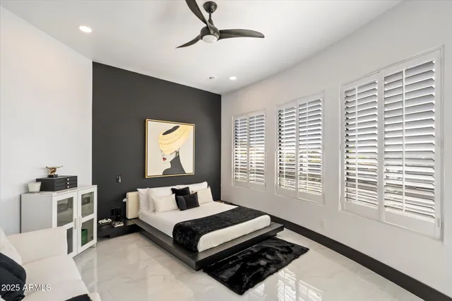 a bedroom with a bed a dresser and window