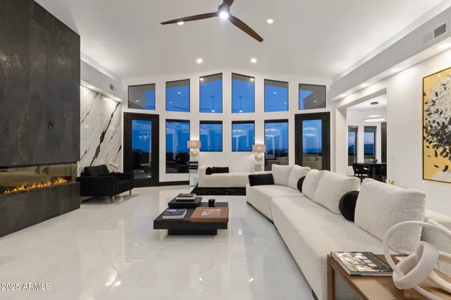 a living room with furniture gym equipment and a large window