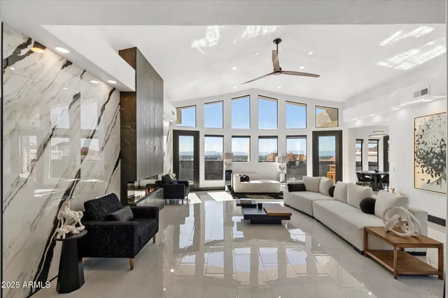 a living room with furniture fireplace and a large window