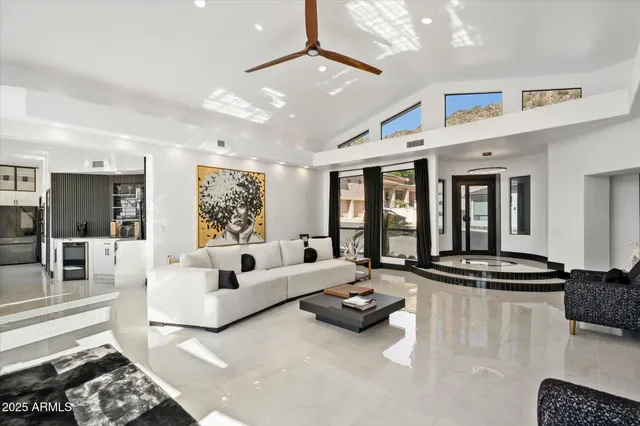 a living room with furniture gym equipment and a chandelier