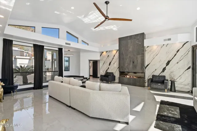 a living room with furniture and a chandelier