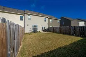 a view of a house with backyard and porch