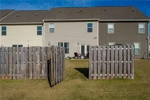 a view of a house with wooden fence
